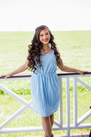 A lovely blue summer dress with tie waist and elegant texture on the fabric.  