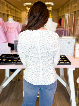 Sweet Meadow Long Sleeve Top in cream with dainty green and blue floral print, ribbed knit fabric, and lettuce-trim 