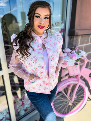 Soft quilted vest with ruffle detail and florals and bow design. Pockets. 