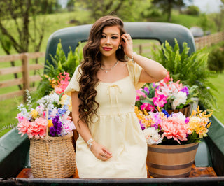 The perfect yellow spring dress. Puffed sleeves, a tie detail, and an empire waist make this one a beautiful fit. 