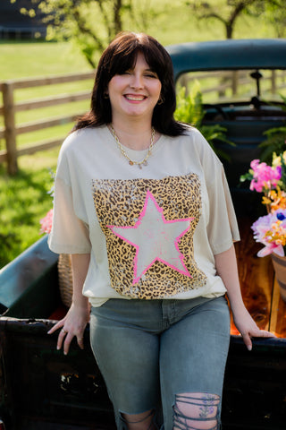 Graphic tee with cheetah and star design. 