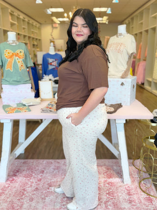 Plus size cream colored floral sweatpants 