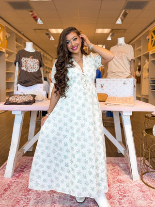 This floral maxi dress is the ultimate boutique must-have for fall. Designed with romantic puff sleeves, a flattering tie-front detail, and a flowy silhouette, it’s perfect for everything from a brunch outfit to a weekend stroll. The soft white floral print makes it easy to style, whether you’re dressing it up with boots or keeping it casual. 