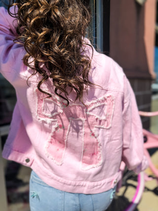 Light weight embroidered jacket with floral and bow design. 