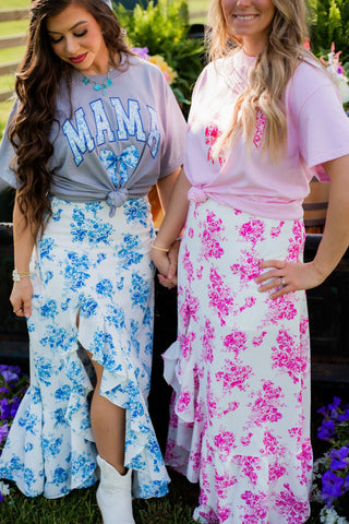 An elegant floral maxi skirt in pink or blue. The side skirt with ruffle make it perfect to dress up or down! 