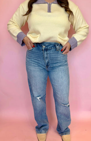 Kan Can brand light wash denim with slight distressing, straight leg fit, and cross over waist line. 