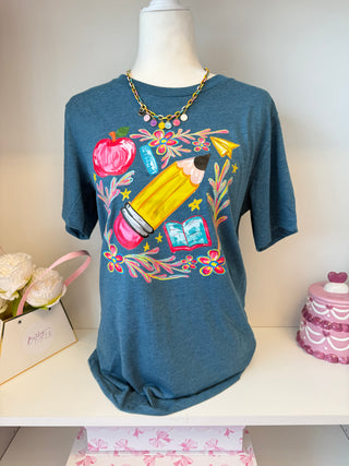 Teal blue back-to-school graphic t-shirt with pencil, apple, ruler, and floral illustrations – teacher or st