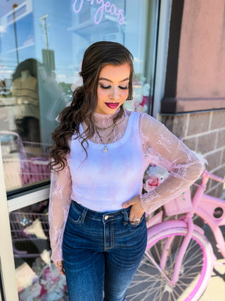 Romantic sheer lace long sleeve top layered over a ribbed tank. Available in pink & blue at Bailey Kate Boutique. Perfect for date nights, girls’ night out, or everyday chic.