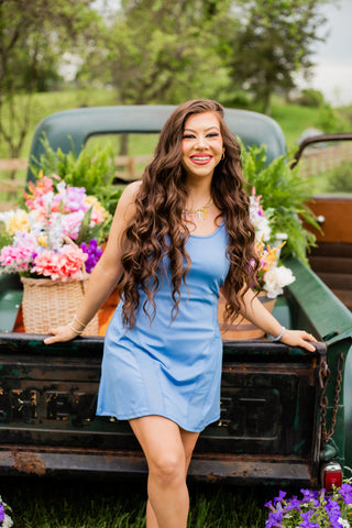 A blue athletic dress with spaghetti straps and shorts underneath. 