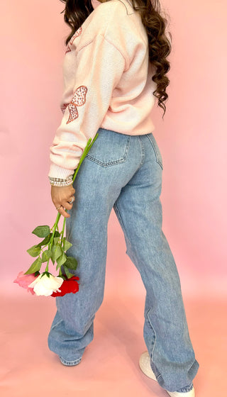 Kan Can brand light wash denim with slight distressing, straight leg fit, and cross over waist line. 