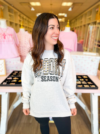 Spooky Season sweatshirt with checkered, leopard, striped, and festive Halloween prints—cozy gray fall pullover for pumpkin patch, trick-or-treat, and autumn style.