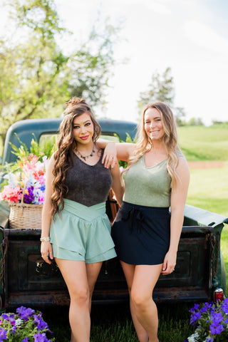 Acid wash v neck bodysuit available in a mineral wash black or sage green color. 