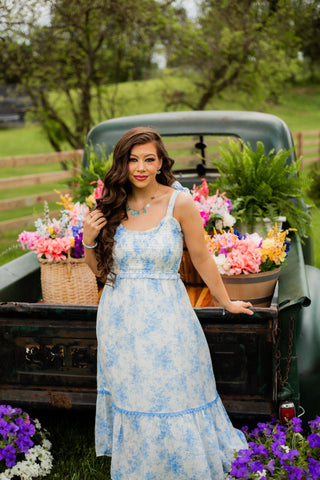 A beautiful floral dress in the prettiest baby blue color. Offering a smocked top, empire waist, and functional straps, it’s a must get. 